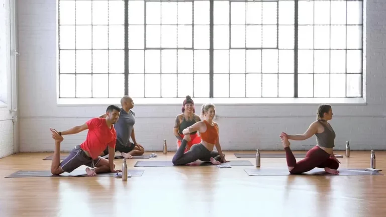 Group of people practicing yoga in studio