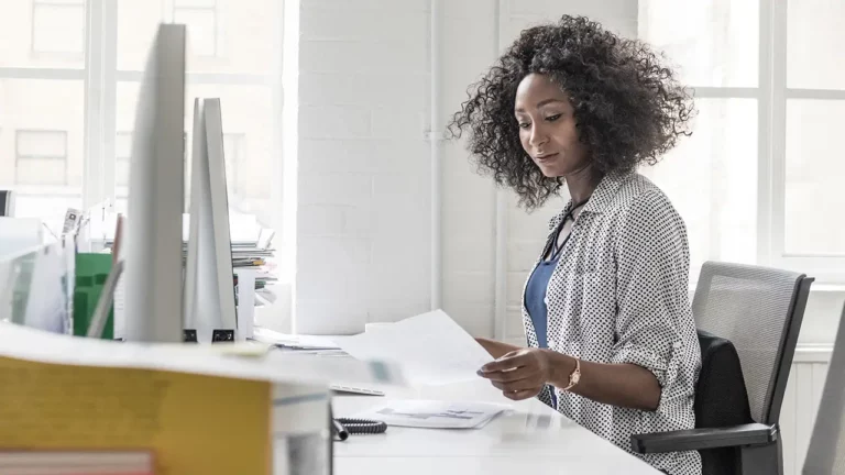 woman looking at invoices hoping for automated AP solution