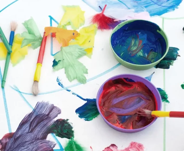 colorful paint and paintbrushes