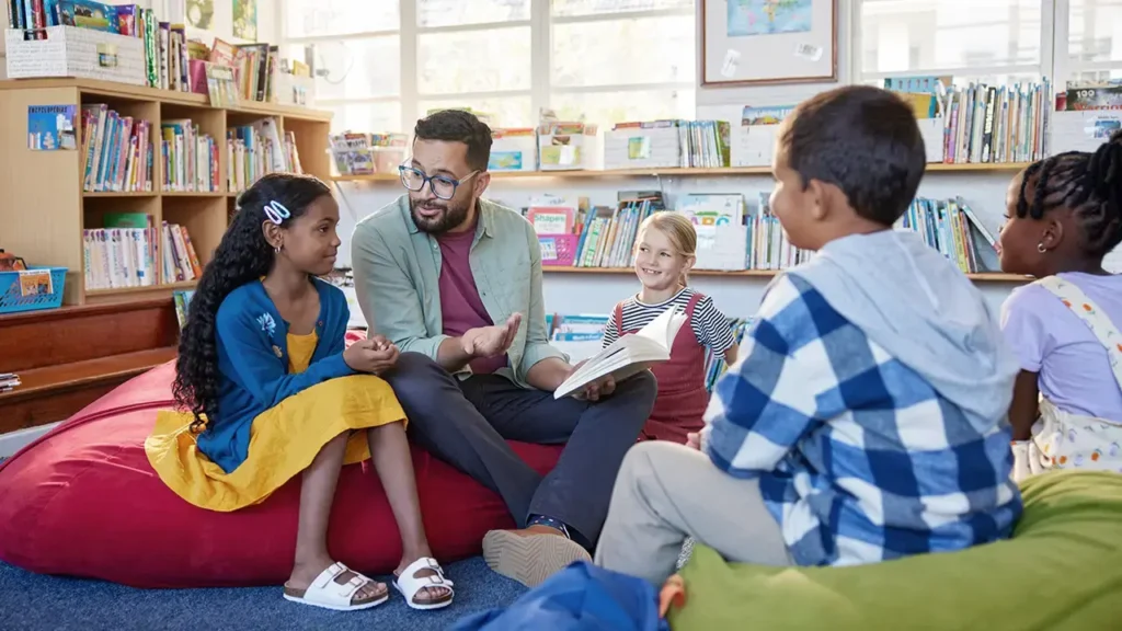 teacher sitting in a circle with children at early childhood education center