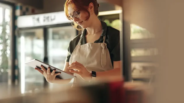 retail worker using retail asset management software to simplify store management